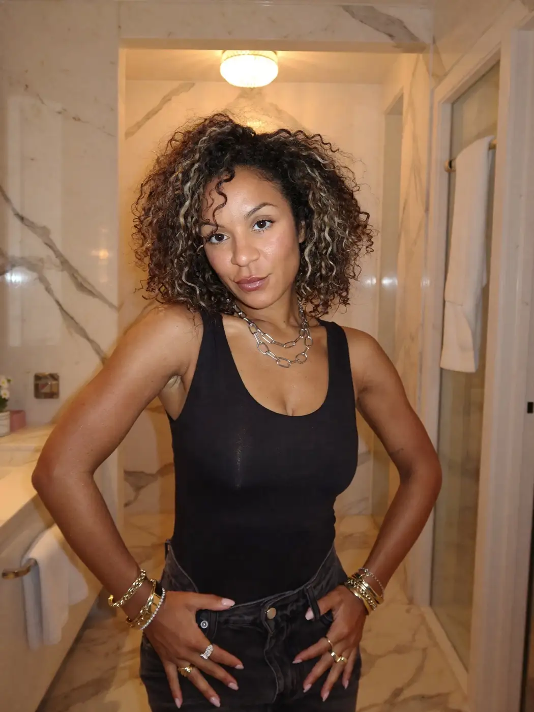 MissFluo in a black top, in a marble room